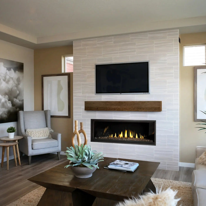 Napoleon Ascent Linear Premium 56 gas fireplace in a white tile wall under a TV and wood mantel