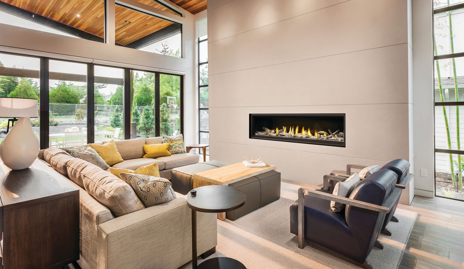 Napoleon Vector 74 linear gas fireplace in a bright living room with a wood ceiling and tall windows