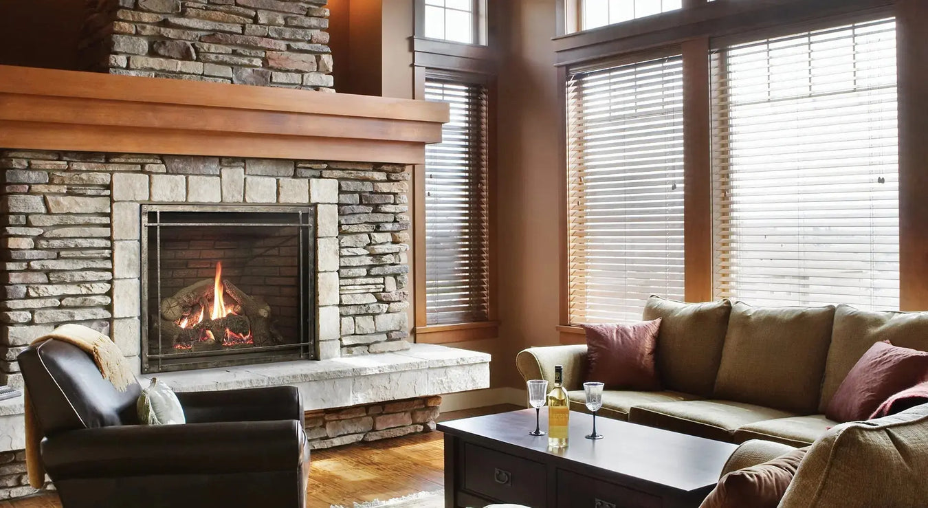Empire Rushmore clean-face direct vent fireplace in a stone chimney breast beside a sofa