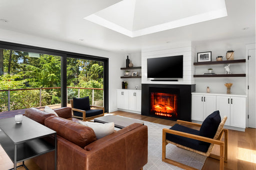 Amantii Classic Edition Electric Fireplace by Fire & Ice - installed in a white media wall in a living room with a leather sofa