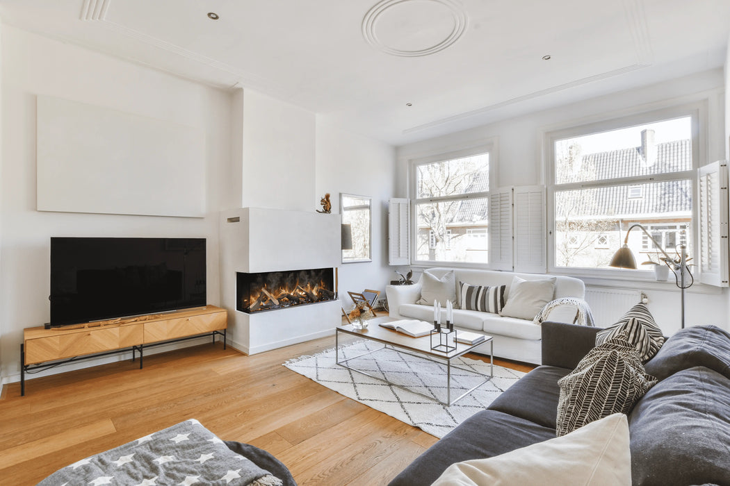 Amantii TruView Signature 3-Sided Glass Electric Fireplace - installed in a white wall beside a TV console