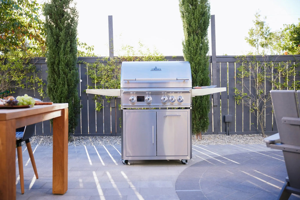 Blaze LTE PRO 32" freestanding gas grill on a patio beside an outdoor dining table, hood closed
