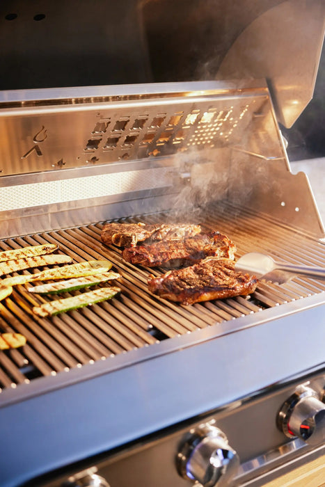 Steaks and vegetables cooking on the grates of a Blaze LTE PRO 40" gas grill