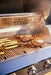 Steaks and vegetables cooking on the grates of a Blaze LTE PRO 40" gas grill