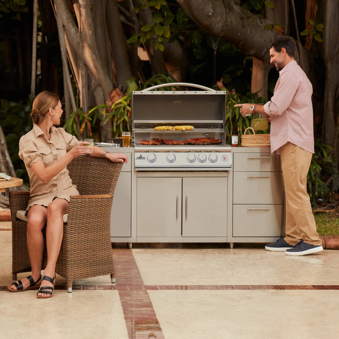 Couple at an outdoor kitchen island with a Blaze LTE+ Marine Grade 32" built-in gas grill