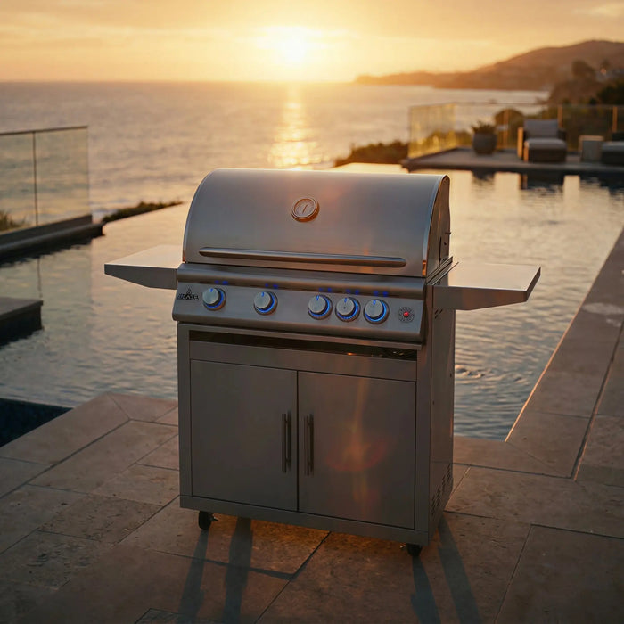 Blaze LTE+ Marine Grade 32" freestanding gas grill beside a pool overlooking the ocean at sunset
