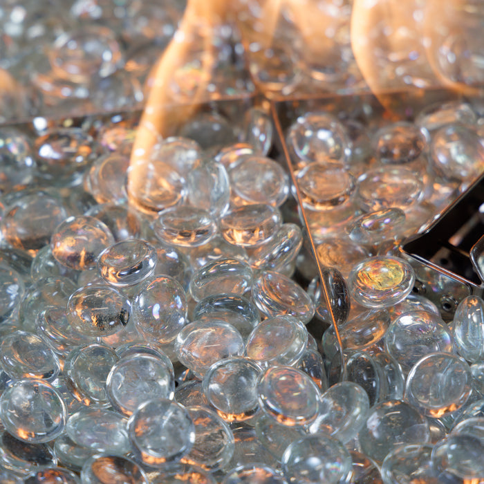 The Outdoor GreatRoom Clear tempered fire glass gems burning in a gas fire pit
