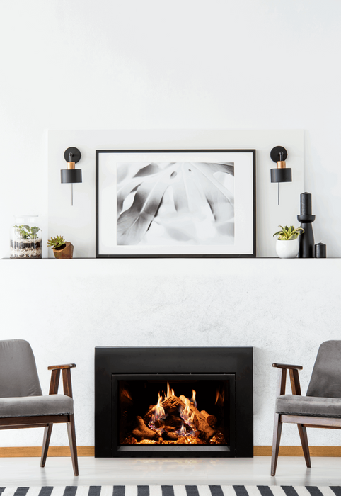 Empire Rainier 34 insert with birch logs and black glass, white wall between grey chairs