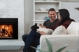 Empire Rainier 34 insert with birch logs and fire-cracked red liner, couple relaxing on a sofa