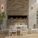 Dimplex Ignite Bold 100" Linear Electric Fireplace - installed in a stacked-stone wall on a covered patio above a dining table