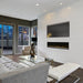 Dimplex Ignite XL 60" Linear Electric Fireplace - installed in a white wall below a TV in a city-view living room