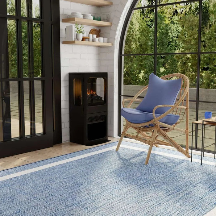Dimplex Optimyst Mapleton Electric Stove MPT-LS-AM - on a blue rug by arched windows