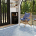 Dimplex Optimyst Mapleton Electric Stove MPT-LS-AM - on a blue rug by arched windows