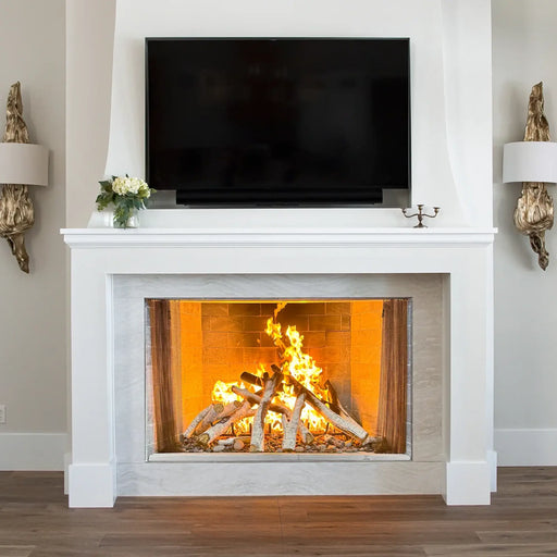 Empire Aspen 60" Traditional Wood Firebox, installed in a white mantel below a TV