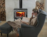 Empire Stove 26" Gateway 2300 Freestanding Wood Burning Stove, stove in a living room beside a reading chair