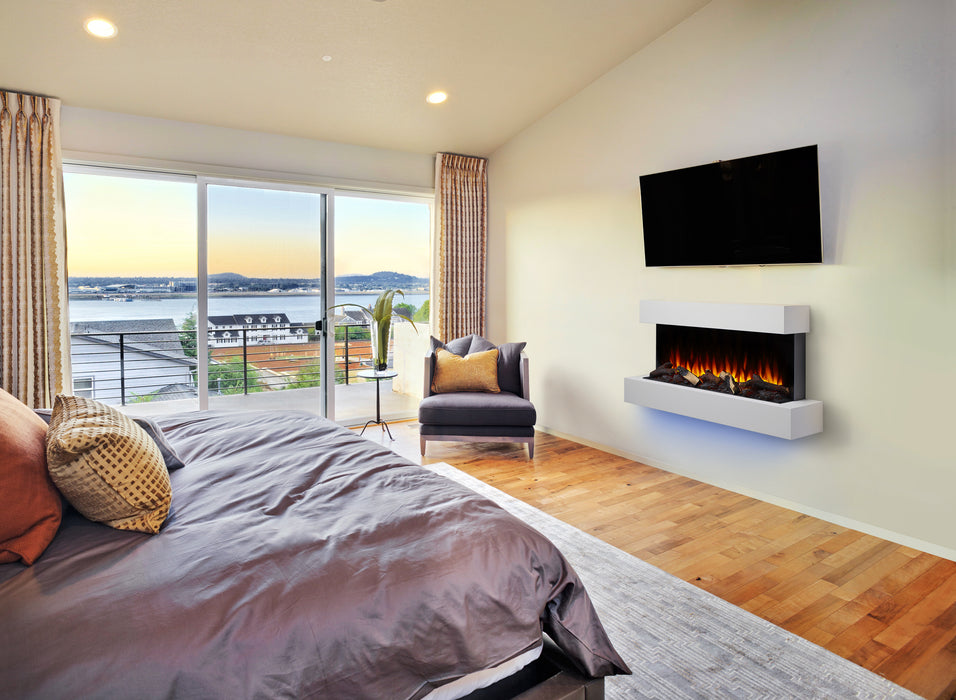 SimpliFire Format wall-mount electric fireplace with white surround below a TV in a bedroom