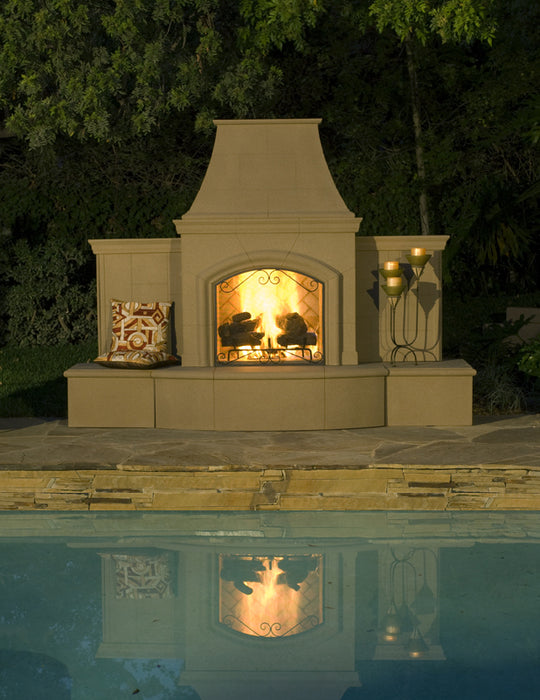 American Fyre Designs Grand Phoenix Outdoor Gas Fireplace beside a pool at night