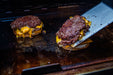 56041 2-sided Porcelain-Enameled Cast-Iron Griddle – in use, with burgers