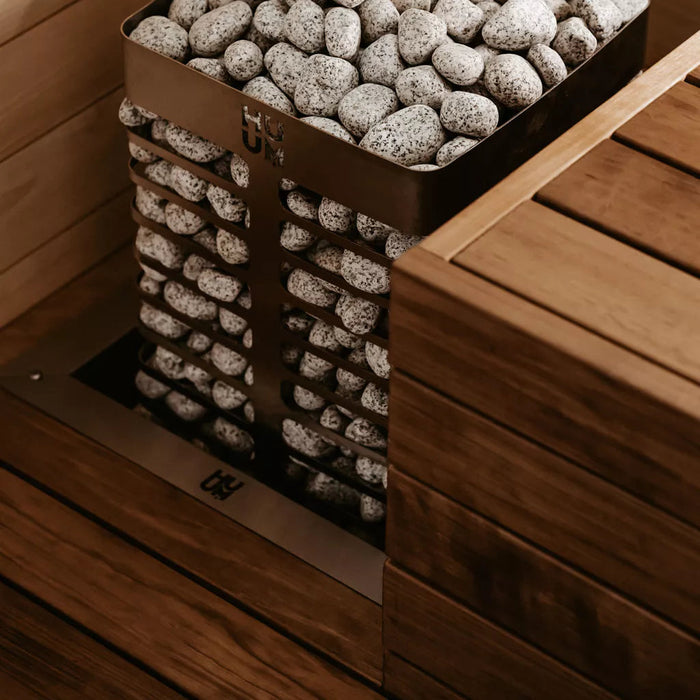 HUUM STEEL sauna heater recessed into a sauna bench with the embedding flange