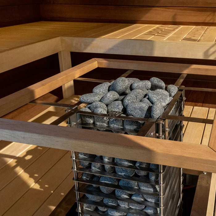 HUUM CLIFF sauna heater with safety rail recessed into a sauna bench