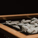Close-up of the HUUM STEEL safety rail around a heater filled with stones