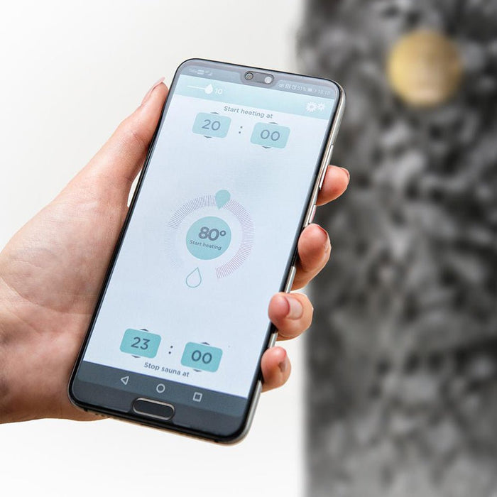 HUUM mobile app on a smartphone held in one hand