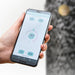 HUUM mobile app on a smartphone held in one hand
