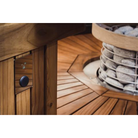 HUUM UKU sauna control mounted on a sauna wall near a HIVE heater