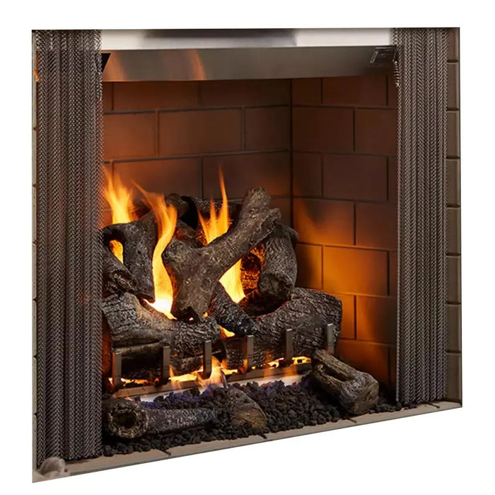 Majestic Castlewood Outdoor Open Wood Burning Fireplace - angled view with logs burning and brick interior