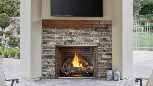 Majestic ODCOUG-42TS Courtyard 42" Vent Free Outdoor Gas Fireplace With Traditional Stacked Concrete Refractory - installed in a stone outdoor fireplace below a TV