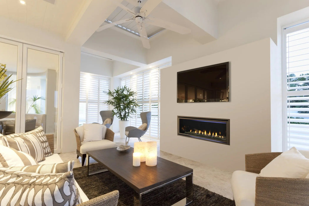 Majestic Jade linear gas fireplace in a room with driftwood logs and reflective panels