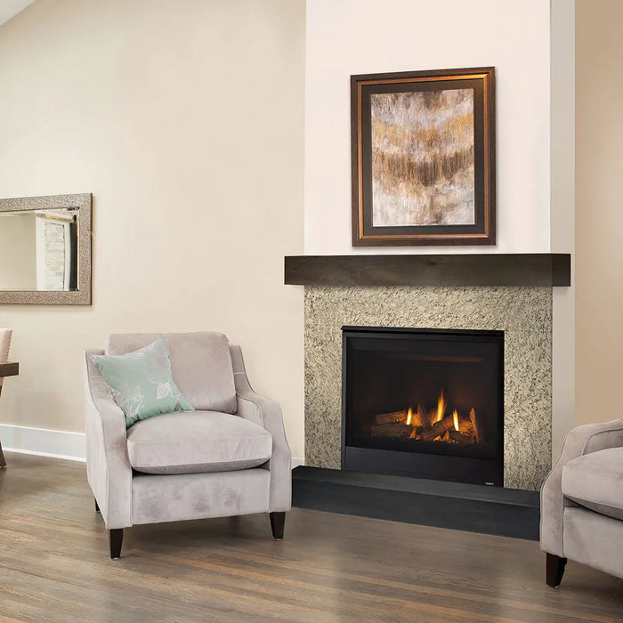 Majestic Quartz Direct Vent Fireplace - installed in a tile surround beside an armchair