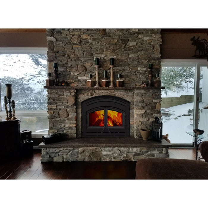 Majestic WARMMAJIC-D WarmMajic II 40" Traditional Wood Burning Fireplace - installed in a stone fireplace between snowy windows, wider view