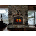 Majestic WARMMAJIC-D WarmMajic II 40" Traditional Wood Burning Fireplace - installed in a stone fireplace between snowy windows, wider view