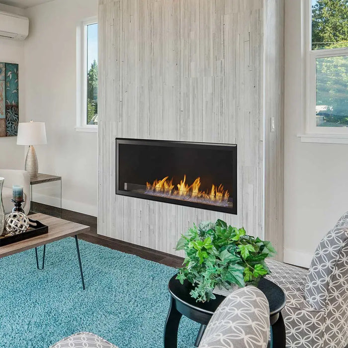 Monessen 42 in. Artisan vent free linear fireplace AVFL42, wider living room view with a table lamp and plant