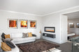 Napoleon CLEARion Elite 60 electric fireplace in a living room, purple lighting with orange flame
