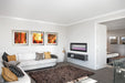 Napoleon CLEARion Elite 60 electric fireplace in a living room, purple lighting with multicolor flame