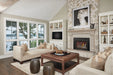 Napoleon Oakville X4 gas fireplace insert in a stone fireplace with birch logs