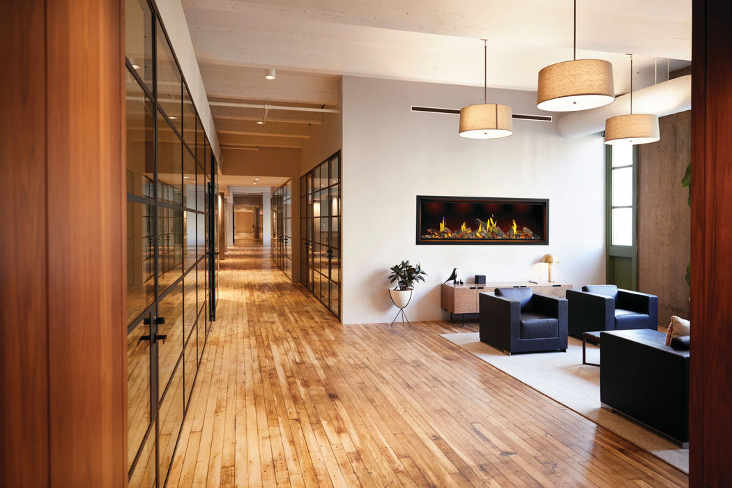 Napoleon Tall Vector 74 gas fireplace with Luminous Logs, in an office lounge with oak logs