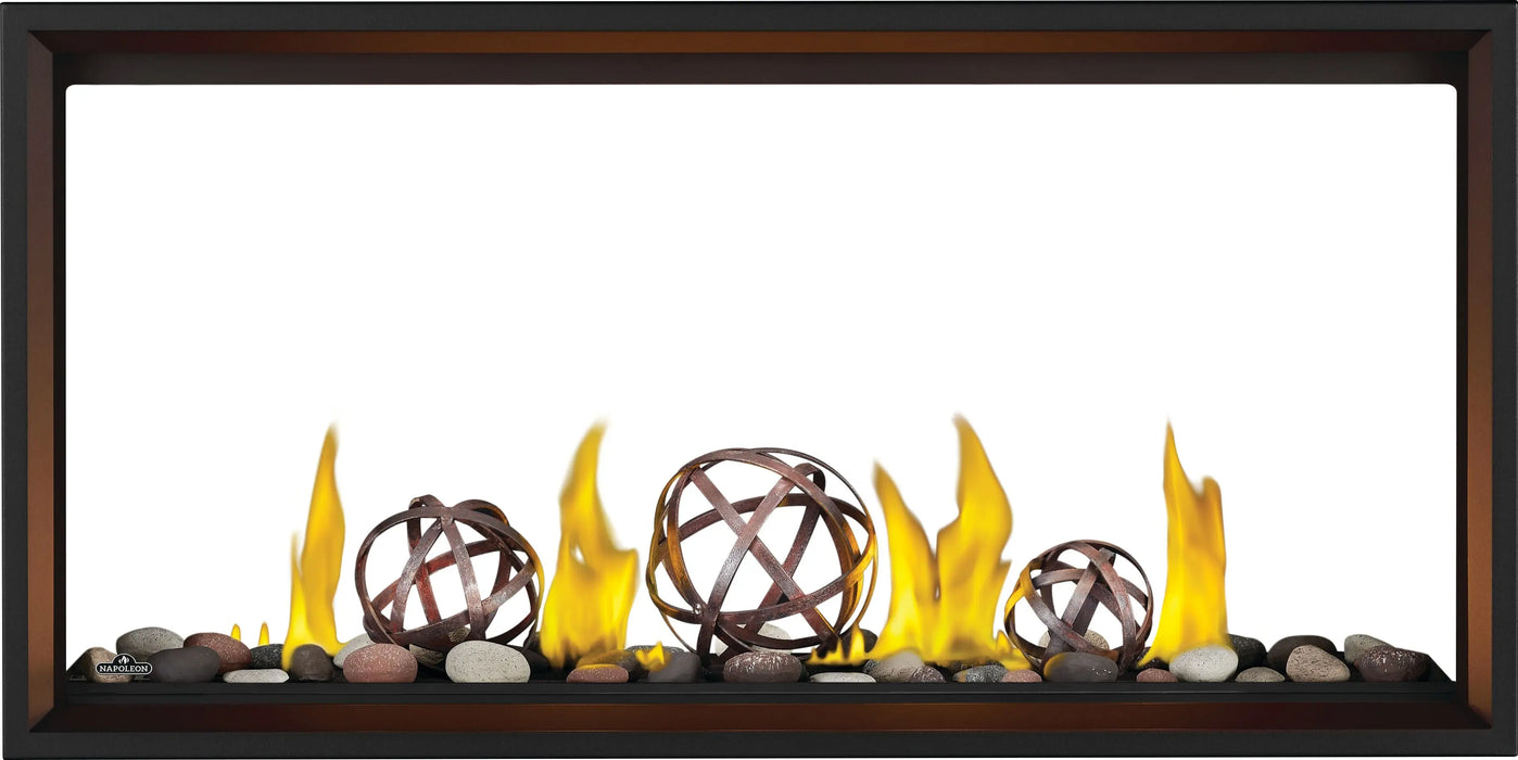 Napoleon Tall Vector 50 see-through gas fireplace, front view with mineral rocks, wrought iron globes