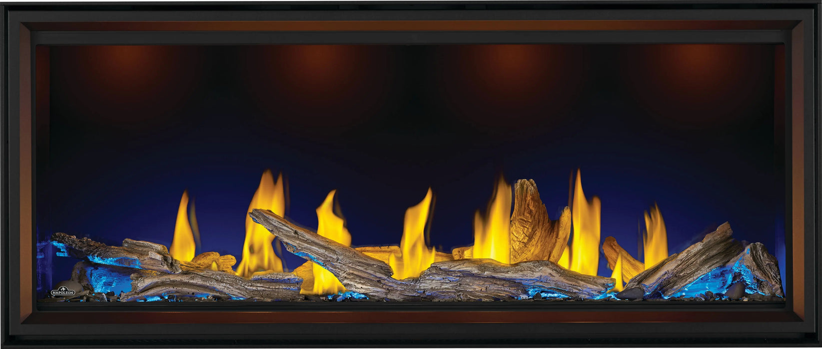 Napoleon Tall Vector 62 gas fireplace, front view with driftwood logs, blue ember lighting