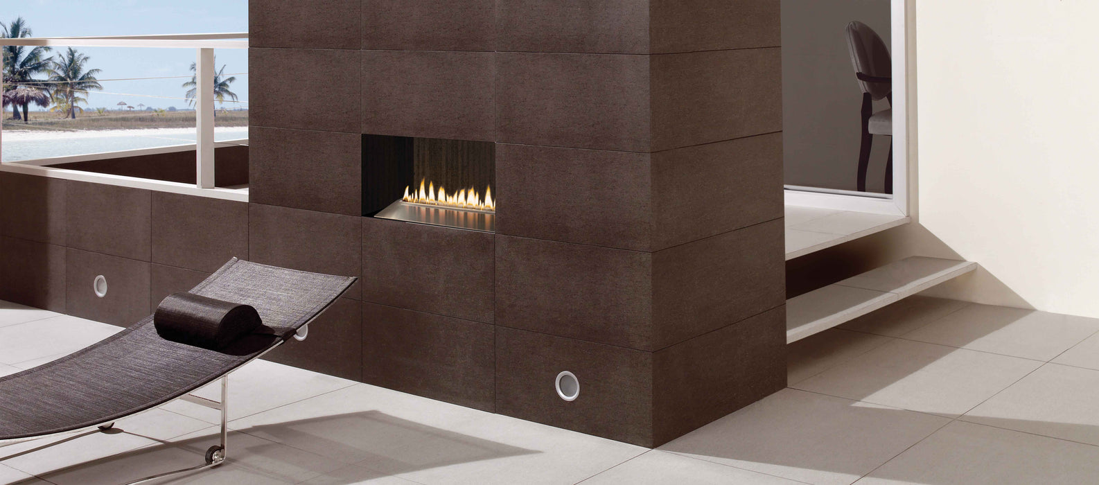 Empire Carol Rose Loft 24 outdoor burner installed in an outdoor fireplace