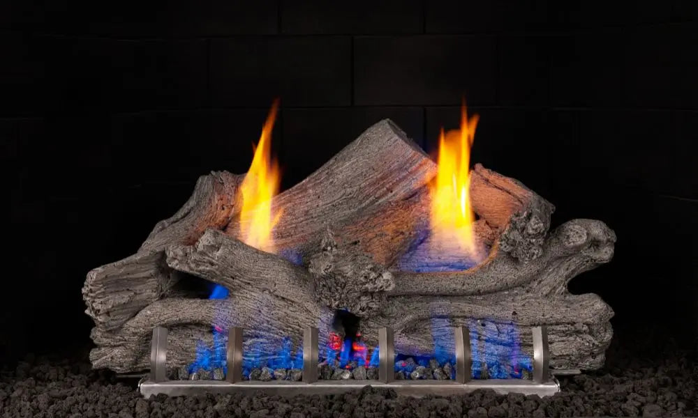 Driftwood gas logs burning on a black background