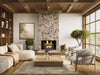 living room with a stone fireplace and gas logs burning
