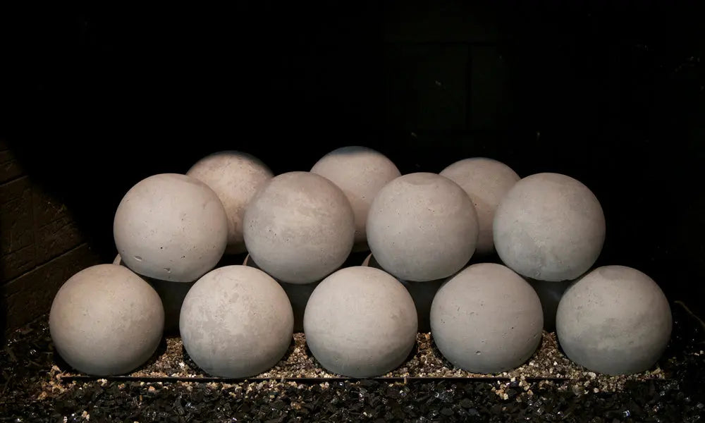 Graystone spheres stacked on a burner, unlit