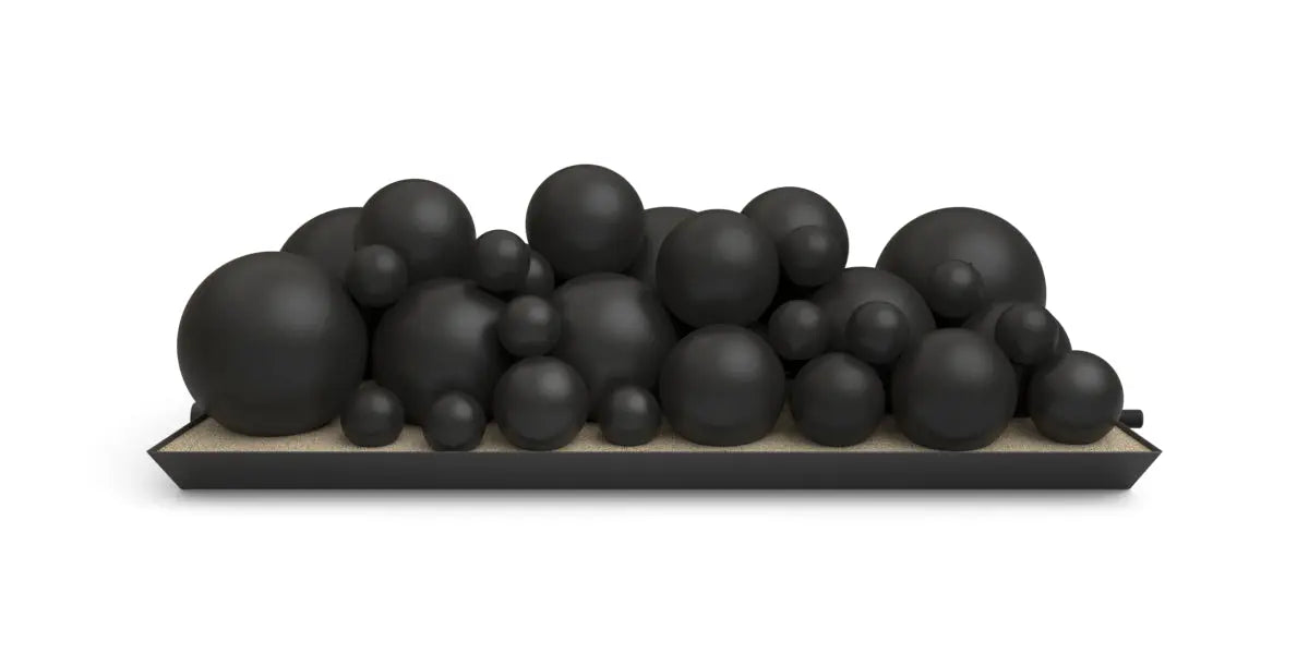 set of black spheres in mixed sizes arranged on a tray