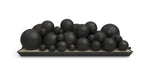 set of black spheres in mixed sizes arranged on a tray