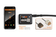 phone showing the Real Fyre control app beside the Bluetooth receiver box and a wood chunk cover