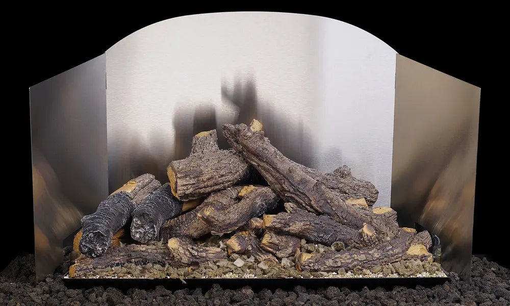 gas logs in front of a satin stainless steel three-panel fyreback
