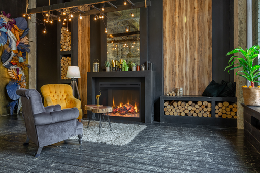 Amantii RusticStone electric fireplace built into a black surround in a dark wood-paneled room with stacked firewood